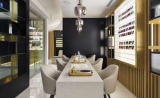 Table with soft lounge chairs on a porcelain tiled floor and various spa products on the shelves