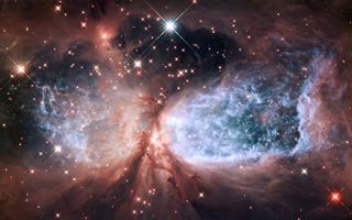 Astrophysics covers topics like star formation. This Hubble image depicts areas of star formation. Stars form when clouds of dust and gas collapse, triggering nuclear fusion inside the dense balls of material.