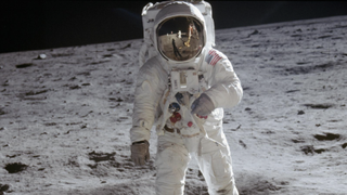 An astronaut walks on the moon