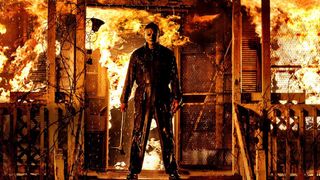 Michael Myers in front of a burning house in Halloween Kills