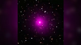 This composite image of the galaxy cluster Abell 2261 contains optical data from NASA's Hubble Space Telescope and Japan's Subaru Telescope showing galaxies in the cluster and in the background, and data from NASA's Chandra X-ray Observatory showing hot gas (colored pink) pervading the cluster. The middle of the image shows the large elliptical galaxy in the center of the cluster.
