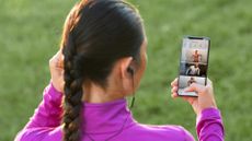 Woman looking at the Peloton App on a smartphone