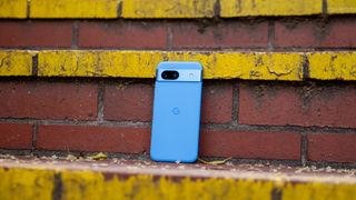 A Bay blue Google Pixel 8a on a staircase