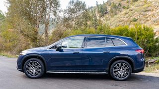 Mercedes EQS SUV parked outdoors in woods