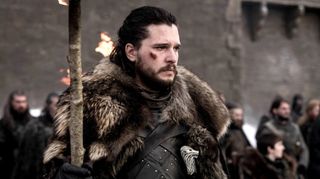 Jon Snow (Kit Harrington) holds a torch in game of thrones