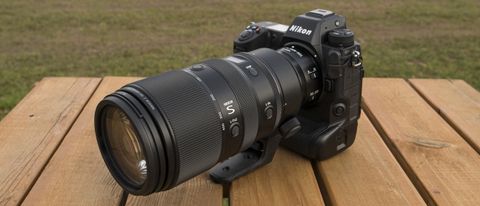 A Nikon Z telephoto lens on a wooden table