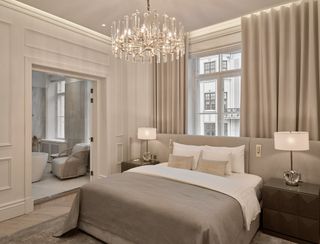 grey and white suite with chandelier at The Hotel Maria