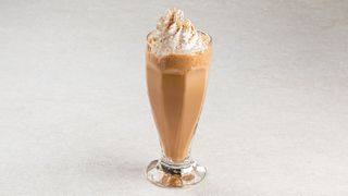 A coffee frappe with whipped cream on top