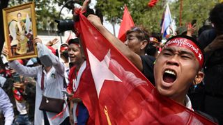 Protesters hold a Myanmar flag during a demonstration outside the UN office in Bangkok on February 1, 2024, to mark the third anniversary of the coup in Myanmar.