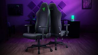 Two Razer Iskur V2 X gaming chairs back to back in front of a desk