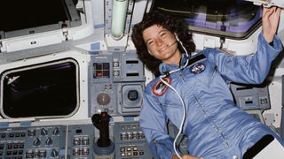 sally ride smiling in cockpit of space shuttle