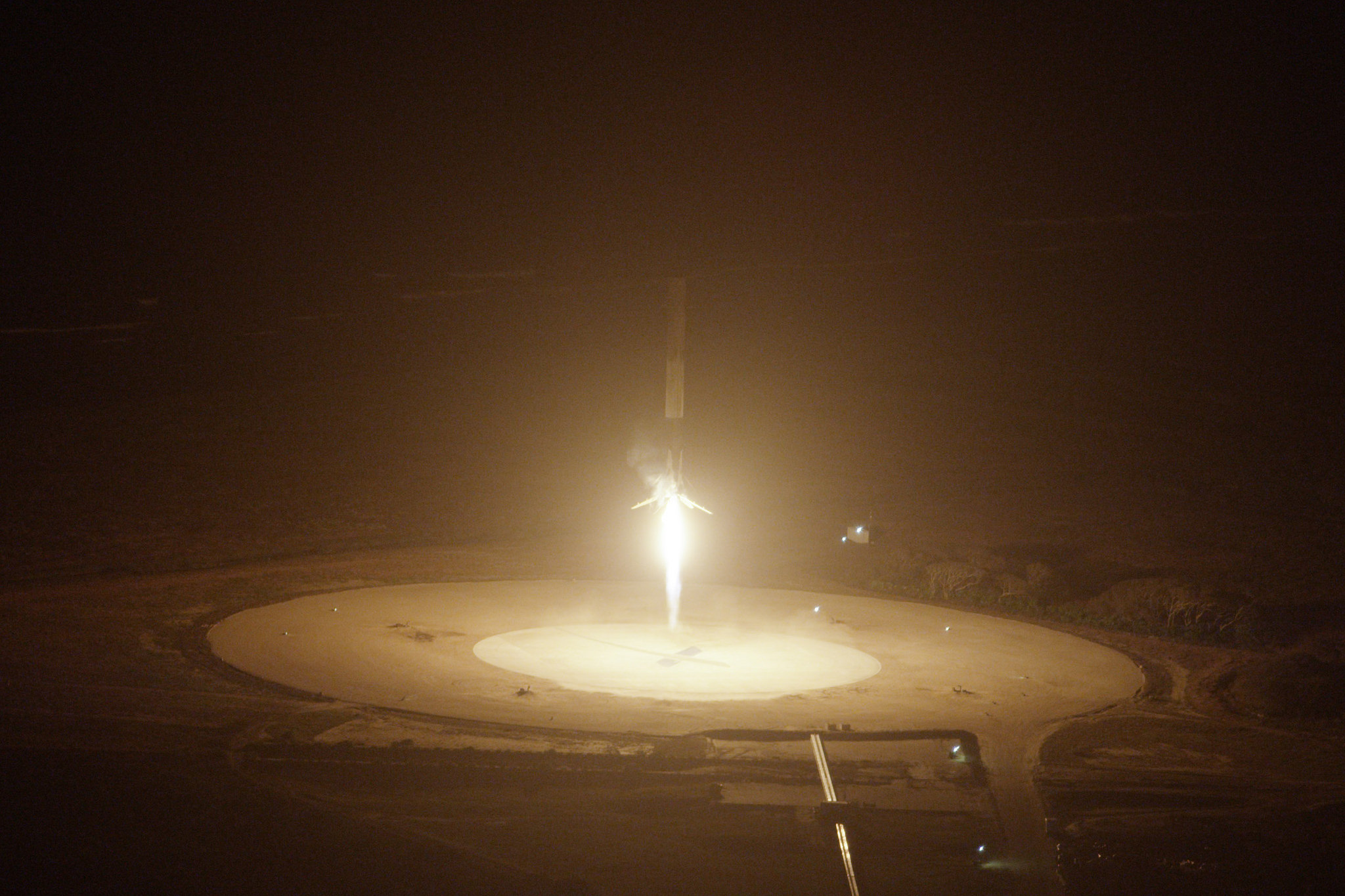 The first stage of SpaceX&#039;s Falcon 9 rocket is seen just before touching down on Landing Site 1 at Florida&#039;s Cape Canaveral Air Force Station on Dec. 21, 2015.