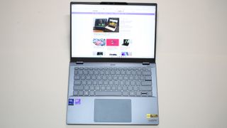 Acer Swift 14 AI (Intel) open on a grey background with the Laptop Mag homepage on the screen