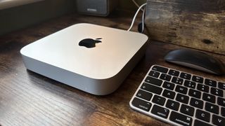 M2 Mac mini on a wooden desk