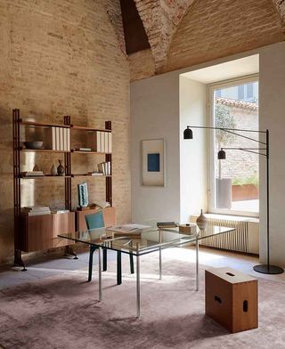 Bookcase behind glass desk