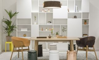 Table, chairs & book shelves in white showroom