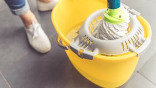 Mop in yellow bucket