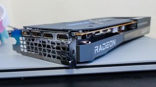 AMD Radeon RX 6600 on top of a laptop, on its side showing its ports