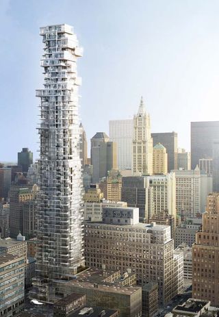 Daytime aerial view of high rise building blocks and skyline, building roof tops, busy roads with cars below, pale blue sky