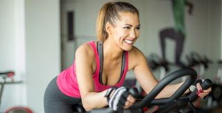 woman riding indoor bike smiling