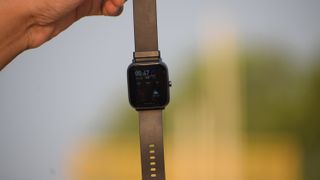 An Amazfit Bip U Pro in someone's hand