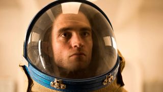 Scene from the movie Mickey 17. Close up of a serious-looking man's face whilst he's wearing a spacesuit/space helmet.