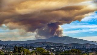 long-range view of a smoke plume behind a mountain