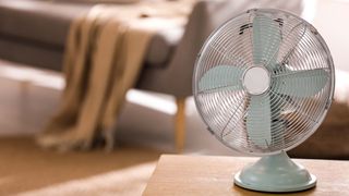 table fan on wooden table