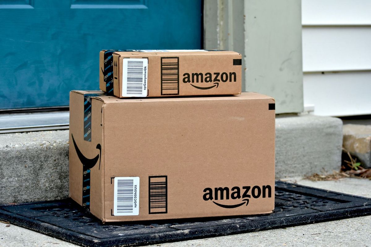 Two Amazon boxed stacked at a doorstop