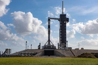 A SpaceX Falcon 9 rocket carrying the Crew Dragon for a critical in-flight abort test launch stands atop Launch Pad 39A of NASA's Kennedy Space Center in Cape Canaveral, Florida for a January 2020 liftoff.