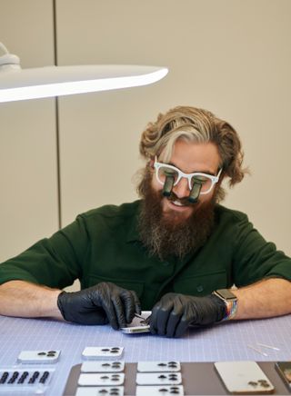 View of an Apple model maker assembling camera modules for the iPhone 13 Pro camera lenses into cosmetic models at Apple Park