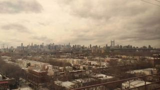 a brown hazy view of new york city from a distance