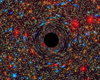 Black holes are galactic monsters with voracious appetites: Once something crosses the monster's event horizon (the black center region in this computer-simulated image of a supermassive black hole), it doesn't come out.