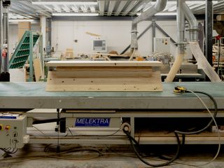 Long wooden bench on a factory table