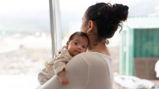 A photograph of a mother holding her baby.