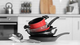 A selection of pans stacked in a kitchen