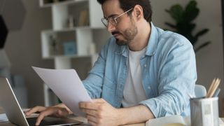 A man filing his taxes electronically on a laptop