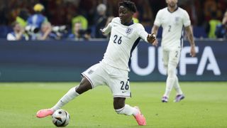 Kobbie Mainoo stretches for the ball in all white kit ahead of the Ireland vs England live stream.