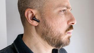 Wearing the OnePlus Buds 3 earbuds.