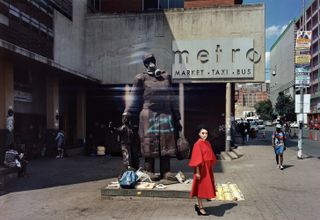 Woman in red stood in front of statue