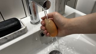 An image showing a person cleaning a Beautyblender