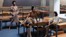 Three women sit in archive Akris in Brutalist library