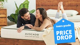 Avocado mattress sales, deals and discounts image shows a man with dark hair and a woman with long brown hair talking while lying on an Avocado Green Mattress