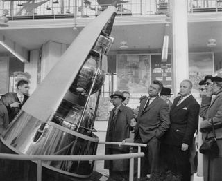 A model of the Sputnik 2 capsule that carried Laika on display at the Soviet Pavilion of the Brussels World Fair held in 1958. The bottom chamber held the dog.