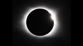 Baily's Beads and a double diamond ring effect at the end of totality of the moon eclipsing the sun.