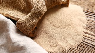 Dried bread yeast cascading out of a sack bag