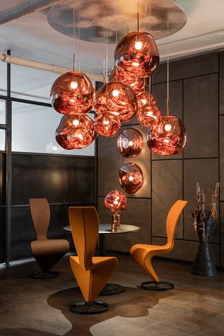 Lighting display above chairs at Tom Dixon's showroom in Soho, New York