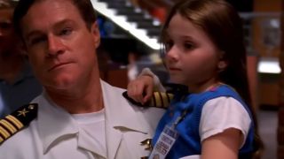 Abigail Breslin being held in the arms of a man in uniform in NCIS