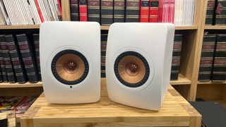 KEF LS50 Wireless II in white finish on wooden rack