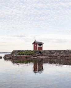 red sauna by rocky beach part of the month's best architecture books